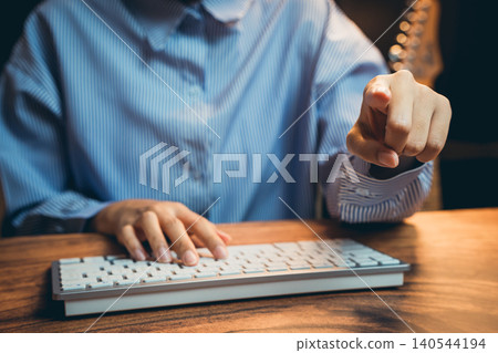 Close-Up of a Business Professional Pointing at a Computer Keyboard While Working in a Modern Office Setup Close-Up of a Business Professional Pointing at a Computer Keyboard While Working in a Modern Office Setup 140544194