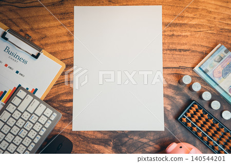 Business concept. Blank Paper on Wooden Table Surrounded by Business Tools and Office Supplies for Creative Ideas Business concept. Blank Paper on Wooden Table Surrounded by Business Tools and Office Supplies for Creative Ideas 140544201