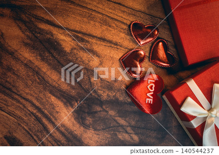 Gift concept. Red Heart Decorations and Gift Boxes on Wooden Table for Celebrating Love and Special Occasions Gift concept. Red Heart Decorations and Gift Boxes on Wooden Table for Celebrating Love and Special Occasions 140544237