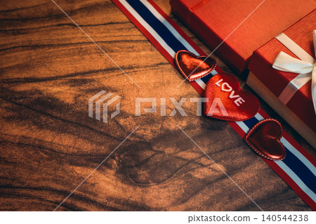 Love concept. Romantic Gifts and Symbols of Love on a Wooden Surface with Red and White Theme Love concept. Romantic Gifts and Symbols of Love on a Wooden Surface with Red and White Theme 140544238