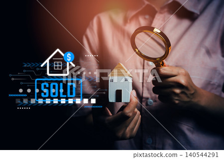 Hand holding small house model and magnifying glass with sold icon, property appraisal, real estate investment, home buying decision, housing market analysis, property sales concept Hand holding small house model and magnifying glass with sold icon, property appraisal, real estate investment, home buying decision, housing market analysis, property sales concept 140544291