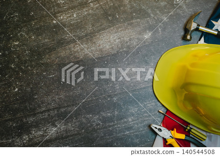 Engineer background. Construction Tools and Safety Gear on Dark Wood Background with Yellow Hard Hat and Various Tools Available Engineer background. Construction Tools and Safety Gear on Dark Wood Background with Yellow Hard Hat and Various Tools Available 140544508