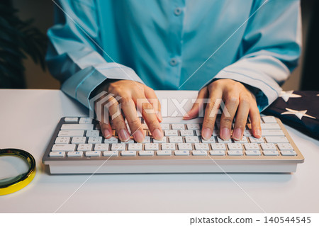 Business concept. Hands Typing on Modern Keyboard in Calm Workspace with Blue Shirt and Stylish Accessories Business concept. Hands Typing on Modern Keyboard in Calm Workspace with Blue Shirt and Stylish Accessories 140544545