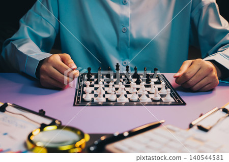 Chess Game. Thoughtful Player Engaged in Strategic Chess Game with Emphasis on Focus and Concentration in Dramatic Lighting Chess Game. Thoughtful Player Engaged in Strategic Chess Game with Emphasis on Focus and Concentration in Dramatic Lighting 140544581