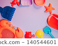 Summer flat lay. Colorful Plastic Beach Toys and Accessories for Summer Fun with Crabs, Starfish, and Sandcastle Tools 140544601