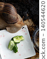 Big snail achatina pet. Animal at home. Eating cucumber veggies food 140544620