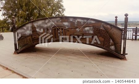 Large Curved Metal Relief Sculpture Depicting City Landmarks and Bear on River Embankment Large Curved Metal Relief Sculpture Depicting City Landmarks and Bear on River Embankment 140544643