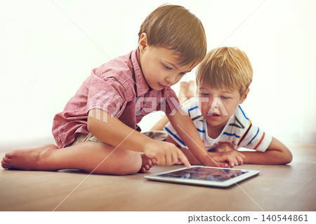 Siblings, children and tablet on a floor with cartoon, gaming or streaming movie at home. Digital, learning and boy kids in house for google it, search or ebook storytelling, app or netflix and chill Siblings, children and tablet on a floor with cartoon, gaming or streaming movie at home. Digital, learning and boy kids in house for google it, search or ebook storytelling, app or netflix and chill 140544861