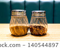 Glass Jars with Spices on a Wooden Table 140544897
