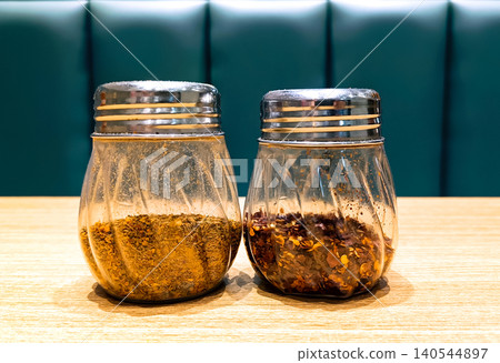 Glass Jars with Spices on a Wooden Table 140544897