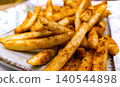 Golden Crispy French Fries on Paper Towel 140544898