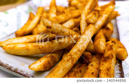 Golden Crispy French Fries on Paper Towel 140544898