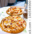 Delicious Freshly Baked Pizza with Toppings on a Plate 140544900