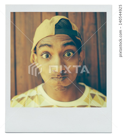 Portrait, funny face and teenager in home with picture at apartment with wood background in India. Cap, goofy and silly young boy with a hat in house with comic facial expression for photo on mockup Portrait, funny face and teenager in home with picture at apartment with wood background in India. Cap, goofy and silly young boy with a hat in house with comic facial expression for photo on mockup 140544925