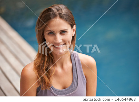 Happy portrait, woman and swimming pool for holiday, vacation and outdoor with wellness and fitness. Face of a young person relax by water for summer, exercise or workout by a hotel or luxury home Happy portrait, woman and swimming pool for holiday, vacation and outdoor with wellness and fitness. Face of a young person relax by water for summer, exercise or workout by a hotel or luxury home 140544968
