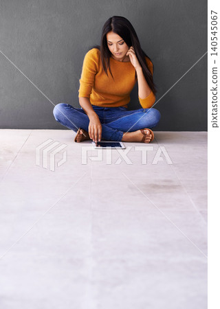 App, social media and internet for woman on floor with tablet for online, web and info on weekend. Blogger or content creator with finger on screen for engagement and tech for browse and relax 140545067