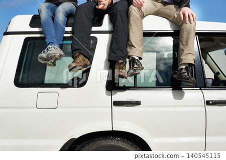 Road trip, people and sitting on jeep, view and route for sightseeing and driving adventure in nature. Legs, traveller and exploration on holiday by blue sky, journey and leisure on vehicle in oman Road trip, people and sitting on jeep, view and route for sightseeing and driving adventure in nature. Legs, traveller and exploration on holiday by blue sky, journey and leisure on vehicle in oman 140545115
