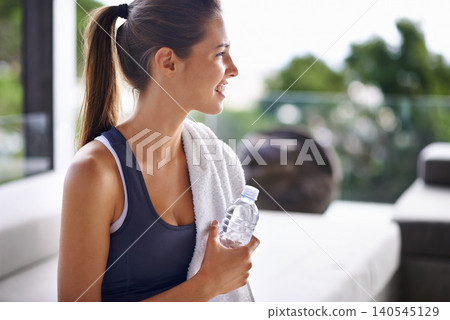 Exercise, bottle and happy woman with water to drink, health and hydration for gym, training and workout. Activewear, trainer or athlete relaxed for fitness, wellness and cardio for vitality 140545129