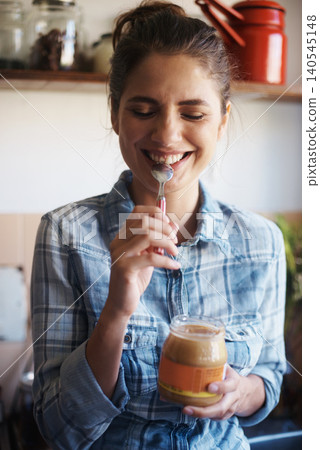 Woman, jar and peanut butter with kitchen, smile and person for food for health and wellness. Nutritionist, spread and protein for nutrition, vitamins or vitality for diet at home or house with spoon Woman, jar and peanut butter with kitchen, smile and person for food for health and wellness. Nutritionist, spread and protein for nutrition, vitamins or vitality for diet at home or house with spoon 140545148