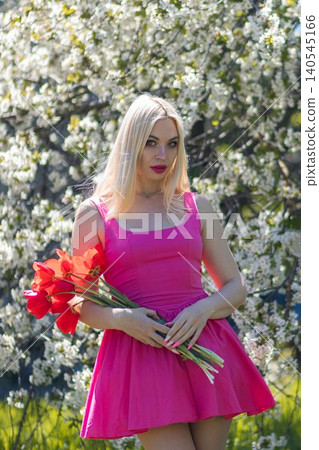beautiful blonde woman in a red dress with flowers 140545166