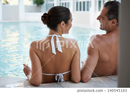 Vacation, hotel and couple relax in pool for swimming, man and woman together with happiness for honeymoon. Resort, female person and guy smile for love in marriage, bonding and girl with bikini 140545183