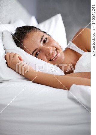 Wake up, relax and portrait of happy woman in bed with wellness, confidence and morning in apartment. Face, smile and girl on bedroom pillow for healthy sleep, weekend comfort or natural rest in home Wake up, relax and portrait of happy woman in bed with wellness, confidence and morning in apartment. Face, smile and girl on bedroom pillow for healthy sleep, weekend comfort or natural rest in home 140545241