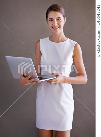 Business, typing and woman with laptop, portrait and employee on a studio background. Person, entrepreneur or PR consultant with computer or internet with website information, tech or online news Business, typing and woman with laptop, portrait and employee on a studio background. Person, entrepreneur or PR consultant with computer or internet with website information, tech or online news 140545242