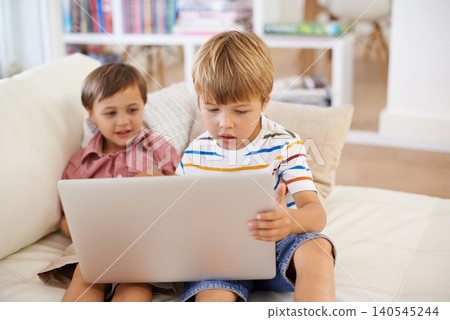 Laptop, love and kid siblings on a sofa with cartoon, film or streaming movie at home. Computer, e learning or children in a living room for search, gaming app and show Laptop, love and kid siblings on a sofa with cartoon, film or streaming movie at home. Computer, e learning or children in a living room for search, gaming app and show 140545244