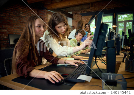 Team working together at computers in busy creative office. Team working together at computers in busy creative office. 140545441
