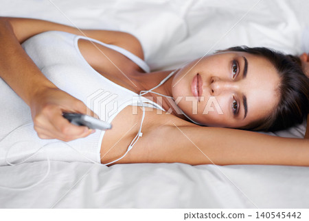 Portrait, listen and music for woman on bed to relax, rest and streaming audio on radio with phone. Digital, technology and podcast for female person in bedroom of apartment, home and mattress Portrait, listen and music for woman on bed to relax, rest and streaming audio on radio with phone. Digital, technology and podcast for female person in bedroom of apartment, home and mattress 140545442