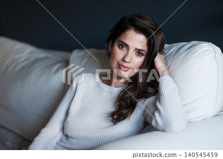 Portrait, woman and sofa with lounge, confidence and style with cotton sweater. Young person, beauty and proud with elegant, rest and relaxation on break in living room at house for comfort on couch Portrait, woman and sofa with lounge, confidence and style with cotton sweater. Young person, beauty and proud with elegant, rest and relaxation on break in living room at house for comfort on couch 140545459