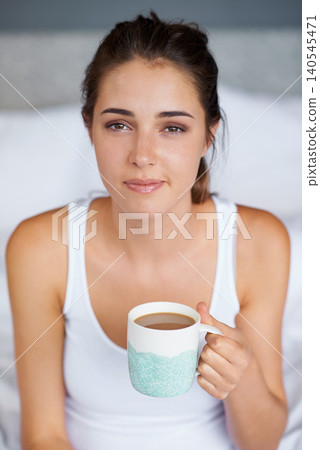 Woman, coffee and portrait in bed for tired in morning for wakeup and drink in cup for warm and strong with milk. Young person with beverage for caffeine on weekend for boost in mug with pajamas Woman, coffee and portrait in bed for tired in morning for wakeup and drink in cup for warm and strong with milk. Young person with beverage for caffeine on weekend for boost in mug with pajamas 140545471