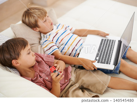 Laptop, relax and kids on sofa in home, learning and family streaming cartoon on internet together. Computer, children and boys in living room for education, movies or brothers with games in house Laptop, relax and kids on sofa in home, learning and family streaming cartoon on internet together. Computer, children and boys in living room for education, movies or brothers with games in house 140545480