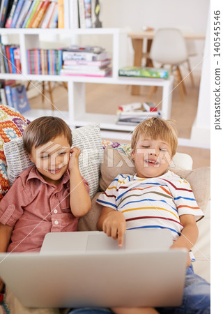 Its story time. Laptop, children and siblings on a sofa with cartoon, film or streaming movie at home. Computer, learning or boy kids in a house for search or ebook storytelling with show. 140545546