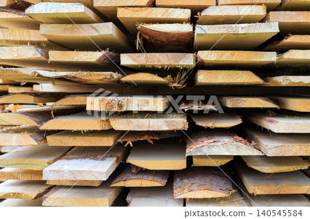 Texture of stacked lumber boards. The raw material from the sawmill is ready for construction, carpentry Texture of stacked lumber boards. The raw material from the sawmill is ready for construction, carpentry 140545584