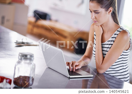 Reading, blog and woman in kitchen with laptop for research for remote work as a writer. Online, article and person scroll on computer and learning from internet about information for writing Reading, blog and woman in kitchen with laptop for research for remote work as a writer. Online, article and person scroll on computer and learning from internet about information for writing 140545621