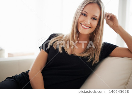 Happy, portrait and woman on a sofa relax with confidence, positive attitude or leisure in her home. Face, smile and female person in a living room with vacation, free time or resting holiday Happy, portrait and woman on a sofa relax with confidence, positive attitude or leisure in her home. Face, smile and female person in a living room with vacation, free time or resting holiday 140545638