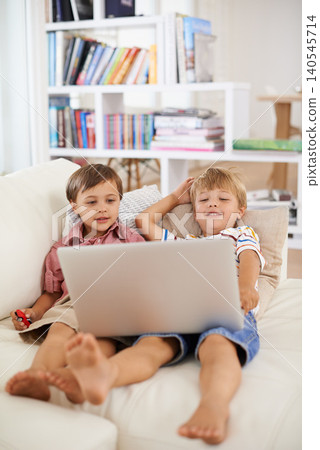 Laptop, smile and kids on sofa in home to relax, learning and family streaming cartoon on internet together. Computer, children and boys in living room for education, movies or brothers with games Laptop, smile and kids on sofa in home to relax, learning and family streaming cartoon on internet together. Computer, children and boys in living room for education, movies or brothers with games 140545714