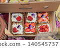Strawberry cakes with cream, edible flowers sit in boxes, Kazanluk Rose Festival food event. Cake display with bakery craft, dessert market, berries, sweets, Bulgarian cuisine 140545737