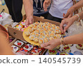Desserts at Kazanluk Rose Festival food event. Hands present desserts and pastries at Kazanluk Rose Festival food event in Rosarium Park. Bakery craft, sweets, sharing, catering, Bulgarian cuisine 140545739
