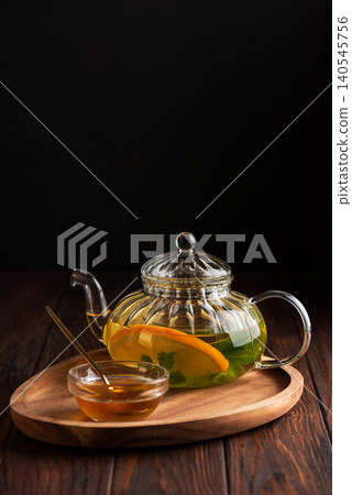 Herbal tea in glass teapot with lemon and honey Herbal tea in glass teapot with lemon and honey 140545756