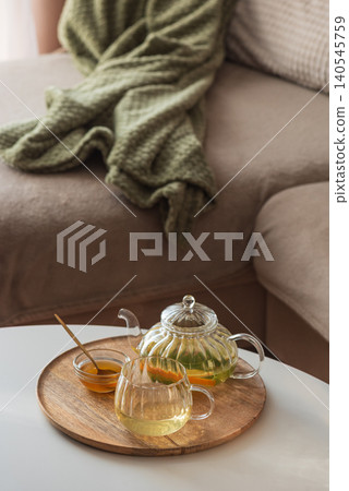 Cozy lifestyle with herbal tea and honey on wooden tray Cozy lifestyle with herbal tea and honey on wooden tray 140545759