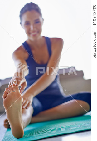 Foot, happy woman and stretching legs for yoga on mat at floor for exercise, wellness and healthy body. Pilates, flexible and closeup of feet in gym for fitness, warm up or wellbeing in Australia Foot, happy woman and stretching legs for yoga on mat at floor for exercise, wellness and healthy body. Pilates, flexible and closeup of feet in gym for fitness, warm up or wellbeing in Australia 140545780