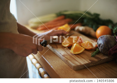 Closeup, kitchen and fruits with woman, vegetables and chopping board with knife and salad. Person, vegan and chef with utensils and ingredients for lunch and supper with healthy meal and diet plan Closeup, kitchen and fruits with woman, vegetables and chopping board with knife and salad. Person, vegan and chef with utensils and ingredients for lunch and supper with healthy meal and diet plan 140545806