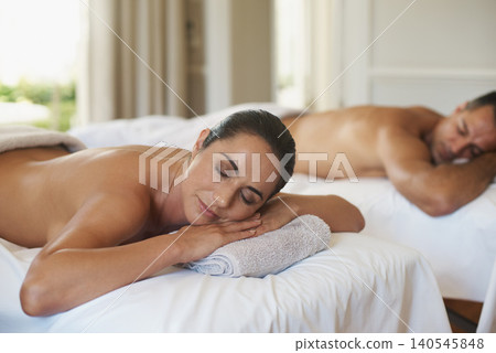 Couple, massage and rest for relax, skincare and salon with luxury wellness and health. Woman, man and towel with spa, happiness and glow for vacation or holiday with holistic care and peace at hotel Couple, massage and rest for relax, skincare and salon with luxury wellness and health. Woman, man and towel with spa, happiness and glow for vacation or holiday with holistic care and peace at hotel 140545848