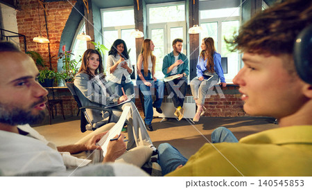 Creative office team having casual group discussion in loft workspace 140545853