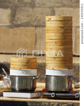 Traditional stacked bamboo steamers at Asian street food market in Karlin Traditional stacked bamboo steamers at Asian street food market in Karlin 140545911