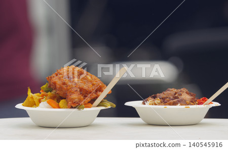 Two bowls of Asian street food with meat, vegetable and rice at Prague Karlin Two bowls of Asian street food with meat, vegetable and rice at Prague Karlin 140545916