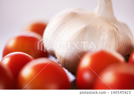 Home, garlic and tomatoes with kitchen counter, ingredients and groceries with recipe and healthy. Wellness, closeup and mockup space with vegetables and nutrition with vegan and organic food Home, garlic and tomatoes with kitchen counter, ingredients and groceries with recipe and healthy. Wellness, closeup and mockup space with vegetables and nutrition with vegan and organic food 140545923