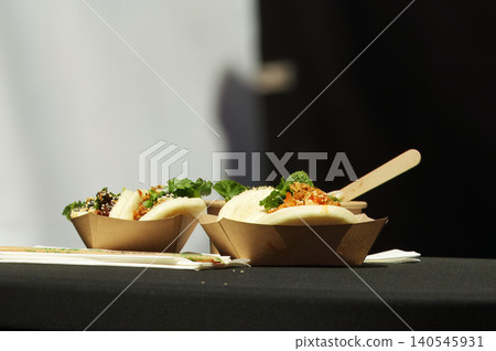 Steamed bao buns in paper bowls at Asian food market in Karlin Steamed bao buns in paper bowls at Asian food market in Karlin 140545931